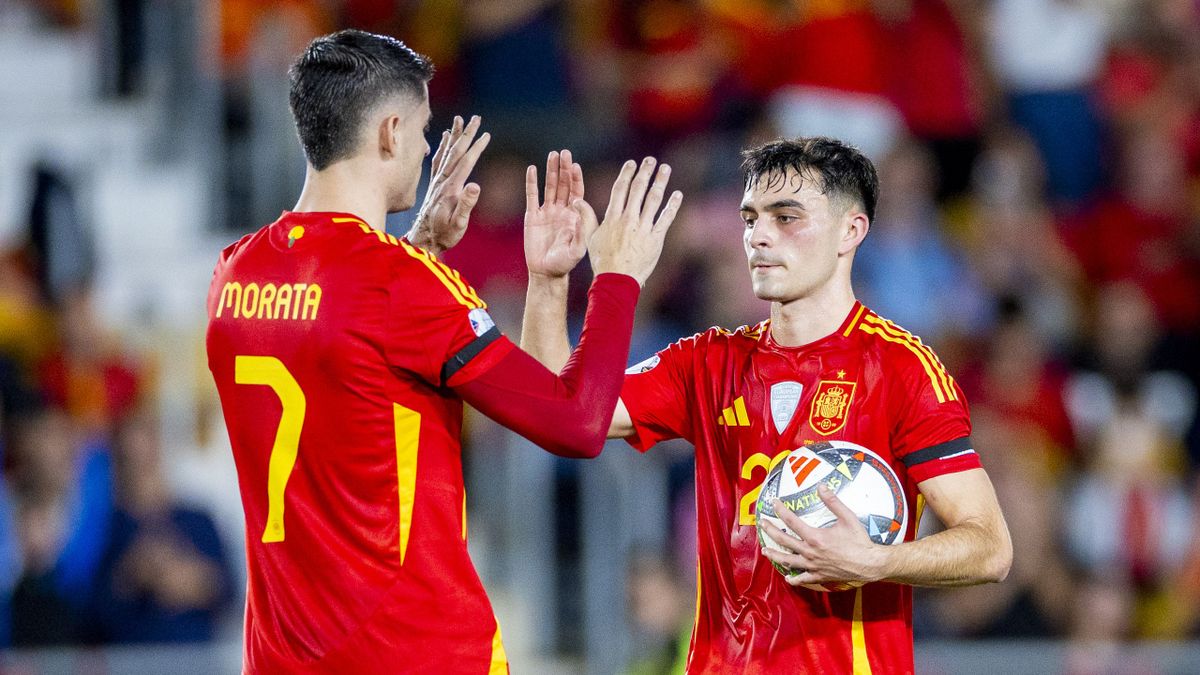 Morata in action for Spain with Pedri.